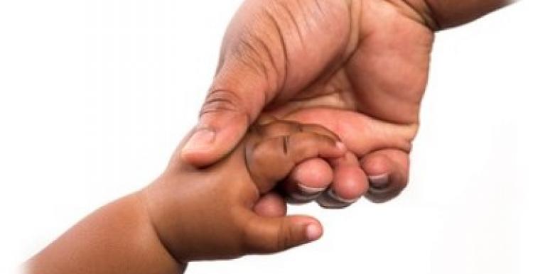 Mother holding baby hand