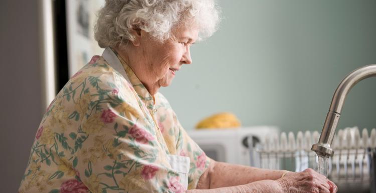 older person washing hands